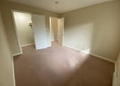 Thumbnail 24 of 51 - a empty room with a carpeted floor and a door to a closet