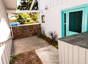 Thumbnail 24 of 25 - a walkway in front of a house with a green door