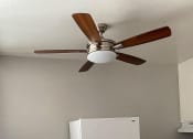 Thumbnail 7 of 10 - a white refrigerator in a kitchen with a ceiling fan