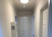 Thumbnail 17 of 32 - a hallway with wooden floors and white doors