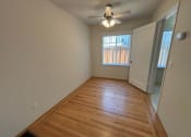 Thumbnail 17 of 19 - a living room with wood flooring and a ceiling fan