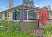 Thumbnail 22 of 27 - A house with a red tree in front.