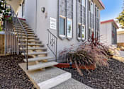 Thumbnail 25 of 29 - the front of a building with stairs and a yard