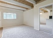 Thumbnail 15 of 32 - A room with a white door and a window with blinds.