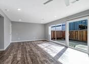 Thumbnail 42 of 53 - a living room with a sliding glass door to a patio