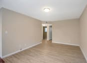 Thumbnail 1 of 13 - a living room with a hard wood floor and white walls
