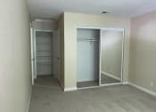 Thumbnail 5 of 26 - an empty bedroom with a closet and a carpeted floor