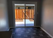 Thumbnail 31 of 47 - A room with a checkered floor and a door leading to a backyard.
