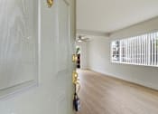 Thumbnail 54 of 63 - A room with a white door and a black bag hanging on it.