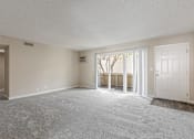 Thumbnail 42 of 51 - A spacious room with a carpeted floor and a window with blinds.