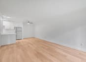Thumbnail 22 of 51 - A room with wooden flooring and white walls.