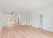 Thumbnail 45 of 51 - A room with wooden floors and white walls.