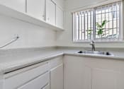 Thumbnail 47 of 52 - A kitchen with a window and a sink.