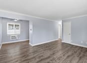 Thumbnail 5 of 17 - A room with wooden flooring and a window with blinds.