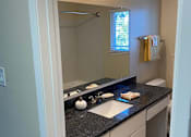 Thumbnail 35 of 43 - A bathroom with a sink and mirror.