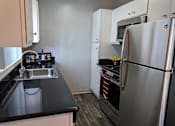 Thumbnail 20 of 63 - A kitchen with a stainless steel refrigerator and a sink.