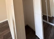 Thumbnail 19 of 36 - a bedroom with a closet and a mirrored closet door
