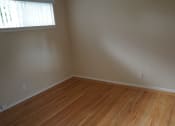 Thumbnail 6 of 22 - an empty room with wooden floors and a window