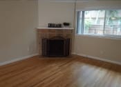 Thumbnail 2 of 22 - a living room with a fireplace and a wooden floor