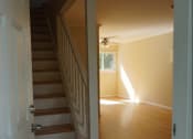 Thumbnail 5 of 22 - a view of a staircase in a home with wood flooring and a white door