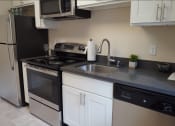 Thumbnail 4 of 22 - a kitchen with a sink and a stove and a refrigerator