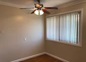 Thumbnail 46 of 62 - a living room with a ceiling fan and a window