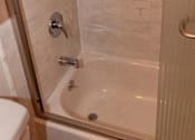 Thumbnail 20 of 25 - a white bathroom with a shower and a toilet