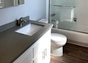Thumbnail 8 of 37 - A modern bathroom with a white toilet and a glass shower stall.