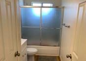 Thumbnail 31 of 32 - a bathroom with a toilet and a shower