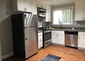 Thumbnail 2 of 14 - a kitchen with stainless steel appliances and white cabinets