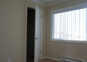 Thumbnail 28 of 31 - an empty living room with a window and a door