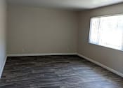 Thumbnail 30 of 42 - A room with wooden flooring and a window letting in sunlight.