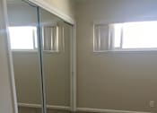 Thumbnail 17 of 26 - a room with a carpeted floor and a mirrored closet