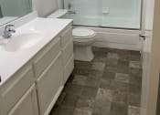 Thumbnail 11 of 26 - a bathroom with a shower and a sink and a toilet