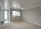 Thumbnail 38 of 60 - A room with a carpeted floor and a ceiling fan.