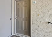 Thumbnail 32 of 37 - A door is open to a hallway with a wall that has a number 11 on it.