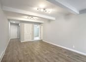 Thumbnail 12 of 27 - A room with a light grey floor and white walls.