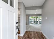 Thumbnail 15 of 53 - a renovated living room with a door to a balcony