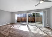 Thumbnail 41 of 53 - an empty living room with sliding glass doors to a patio