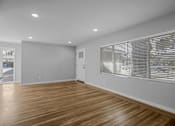 Thumbnail 6 of 31 - A room with wooden flooring and white walls.