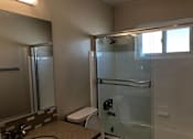 Thumbnail 49 of 62 - a bathroom with a shower toilet and a sink
