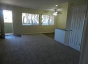 Thumbnail 1 of 14 - A room with a carpeted floor and a ceiling fan.