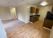 Thumbnail 28 of 51 - an empty kitchen and living room with wood flooring and
