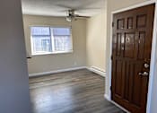 Thumbnail 22 of 43 - A room with a ceiling fan and a door.