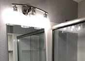 Thumbnail 42 of 47 - A bathroom with a sink, mirror, and shower.