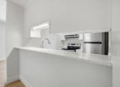 Thumbnail 86 of 92 - A modern kitchen with a stainless steel pot on the stove.