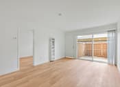 Thumbnail 46 of 51 - A room with wooden floors and white walls.