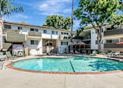 Thumbnail 13 of 43 - A swimming pool surrounded by apartment buildings.