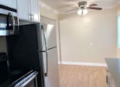 Thumbnail 27 of 62 - a kitchen with a refrigerator and a ceiling fan