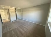 Thumbnail 21 of 31 - an empty room with a closet and a window